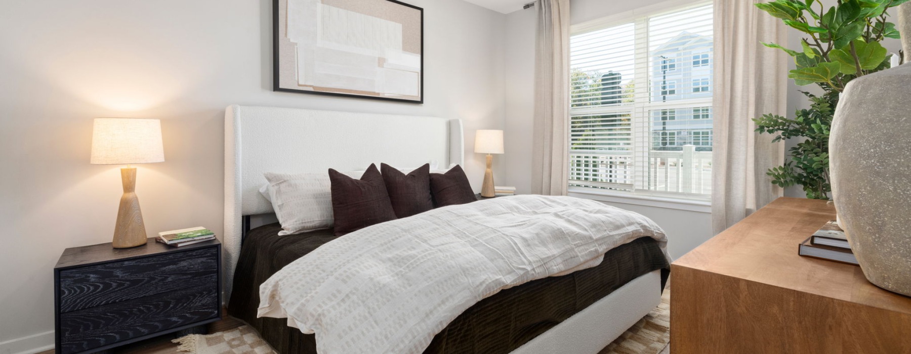 staged bedroom with ceiling fan and picture window